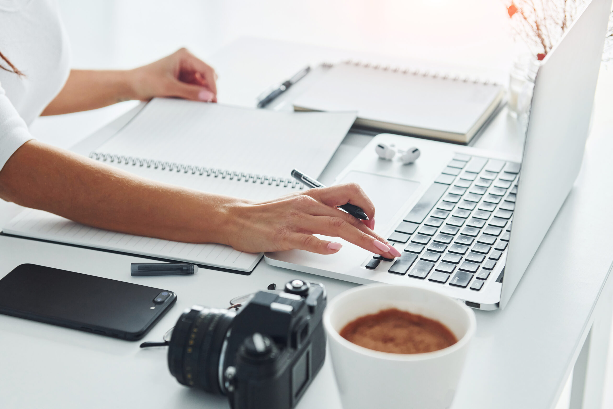 using-laptop-notepad-young-female-freelancer-working-indoors-office-daytime